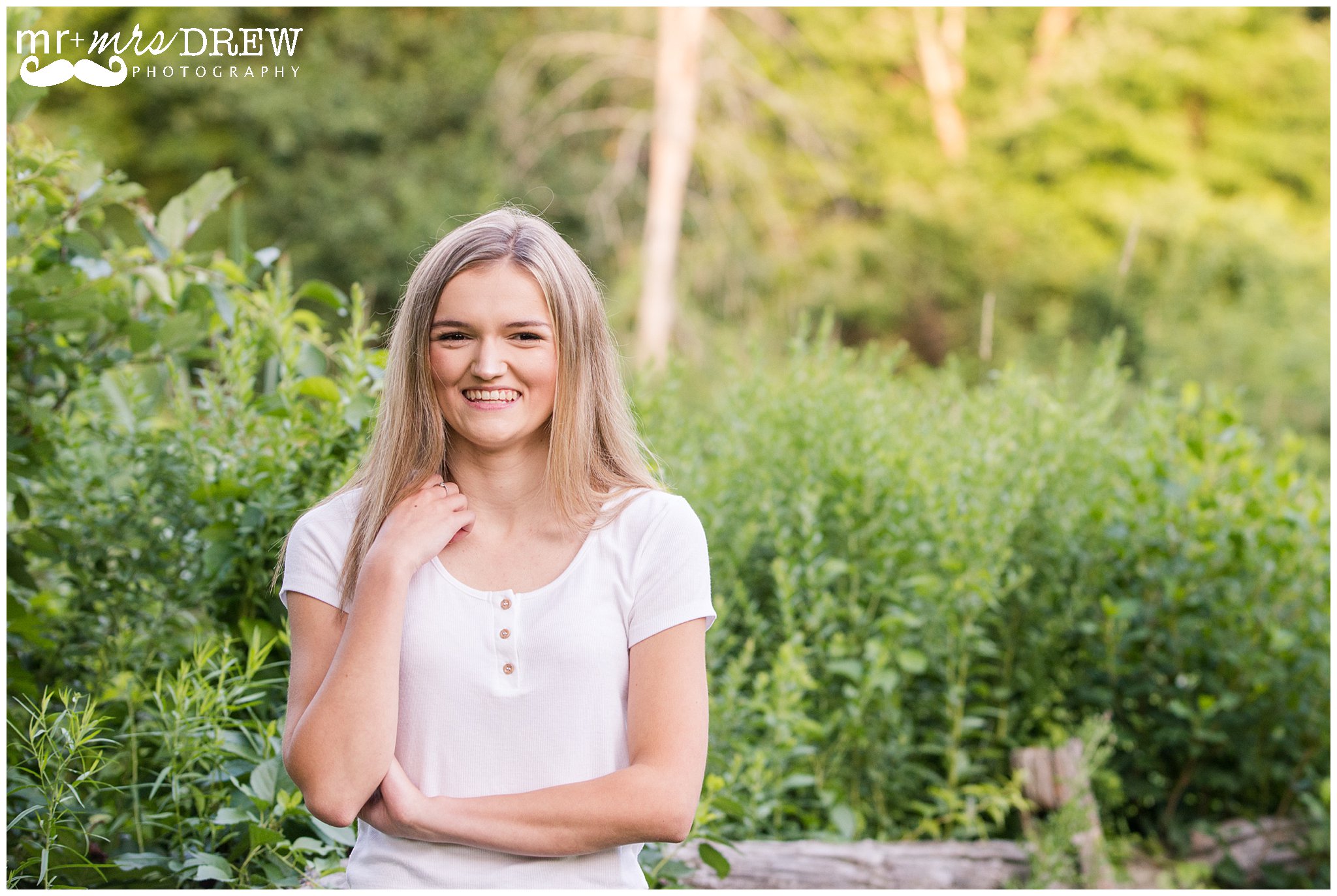 Senior Portrait of girl in white t-shirt looking at camera.