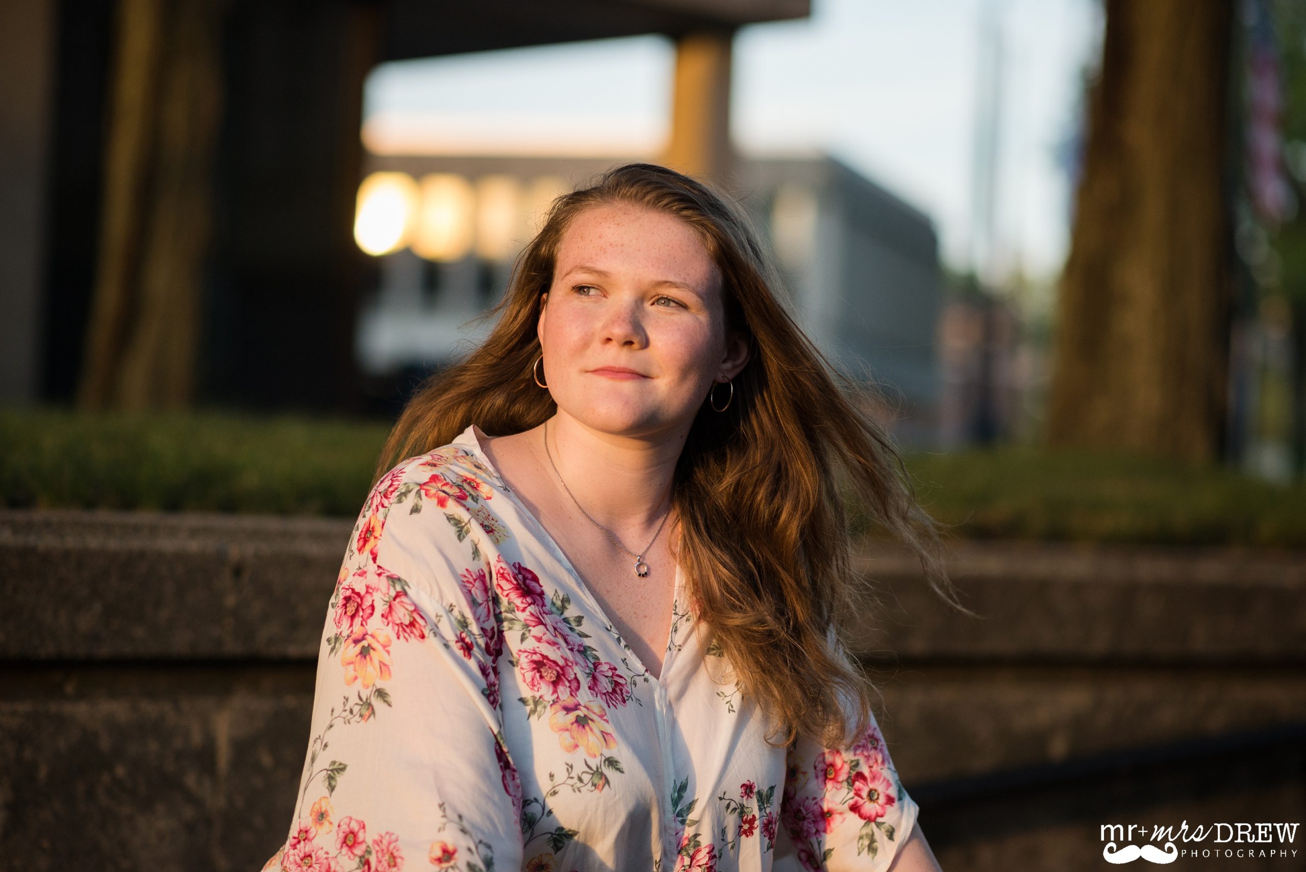 Senior Portraits Downtown Lowell - Meredyth is looking into the sun with a smirk.