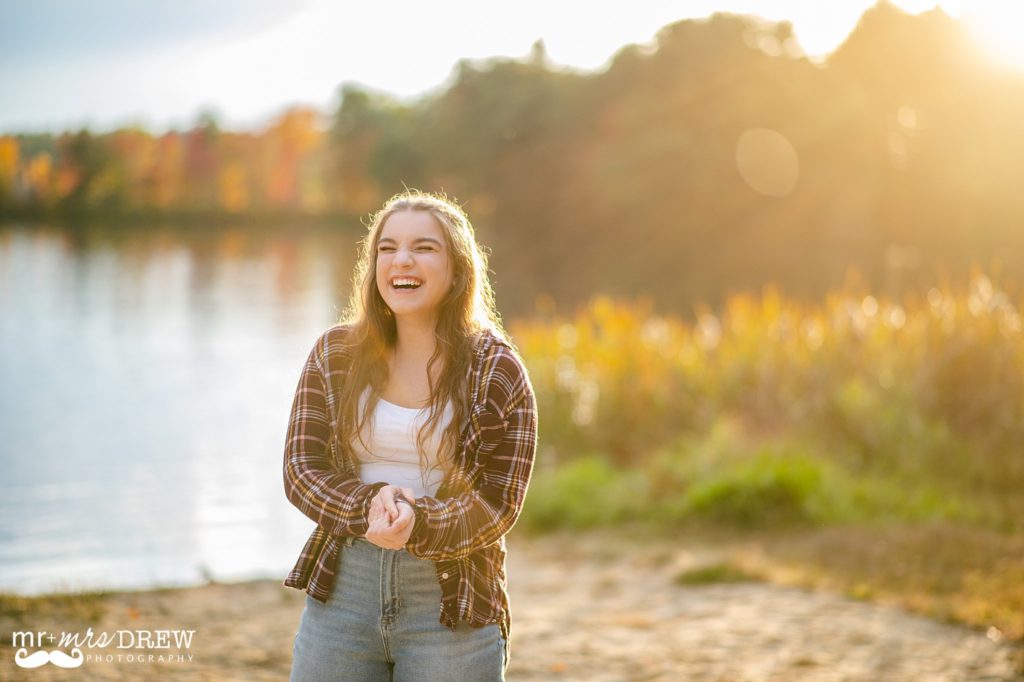 Chelmsford, MA Senior Laughing with sun shining behind at Heart Pond